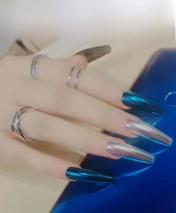 Macro view of long ballerina nails in metallic blue and mirror chrome silver finish