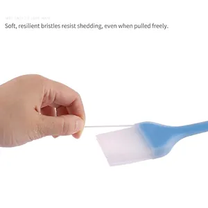 Blue silicone basting brush with flexible translucent bristles for baking and grilling
