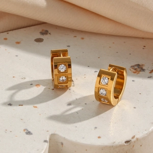 Close-up of 18K gold plated square hoop earrings with three vertical clear cubic zirconia