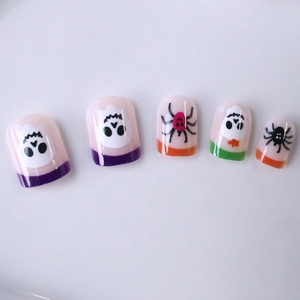 Short square Halloween press-on nails featuring cartoon skulls and colorful spiders