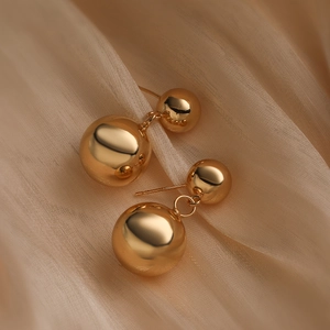 Minimalist gold-plated round ball geometric drop earrings for women on beige silk