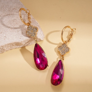 Detail of rose red teardrop earrings with gold plating and white zircon flower accents