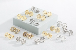 Macro shot of assorted gold and silver bohemian stud earrings on geometric display