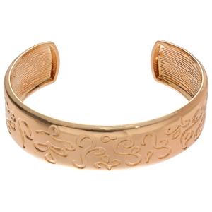 Vintage gold-plated cuff bracelet featuring abstract relief patterns and open design