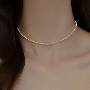 Detailed view of 4-6mm baroque freshwater pearl choker necklace on a model neck
