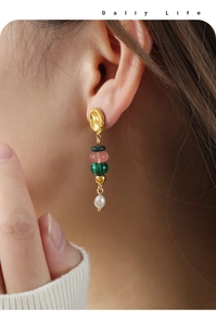 Detail of beaded tassel earrings with green malachite, pink stone and drop pearl