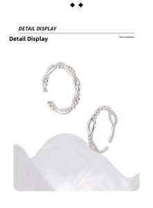 Macro detail of S925 sterling silver couple rings with twisted chain and bead design