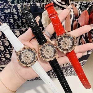 Three fashion leather strap watches for women featuring rotating rhinestone flower dials