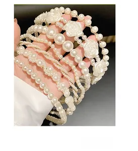 Detail shot of elegant girls' headbands featuring faux pearls and gold metal accents