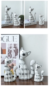 Macro detail of three ceramic cat figurines with elegant black stripes and smooth finish