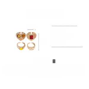 Detail view of 4-piece vintage resin heart rings with hammered texture and 31g weight