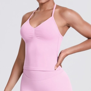 Detail of pink yoga tank top showing seamless fabric and halter neck strap design