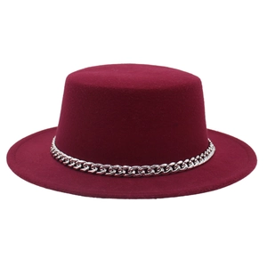 Detail of burgundy wool flat top hat featuring a chunky silver metal chain decoration