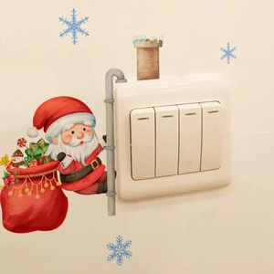 Detail view of Santa Claus and gift box wall stickers applied around a light switch panel