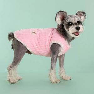 Warm pink fleece dog vest with white pom-pom trim for small pets in winter weather