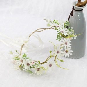 Floral bridal headpiece with white daisies and eucalyptus leaves on a woven vine band