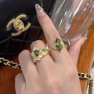 Detail of 14k gold plated emerald ring set with marquise and petal zircon designs