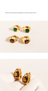 Detailed close-up of vintage emerald and amber zircon stones set in gold hoop earrings