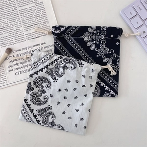 Close-up of black and white paisley drawstring storage bags for jewelry and small items