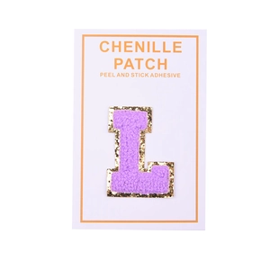 Macro shot of purple chenille letter L patch with gold sequins and adhesive backing
