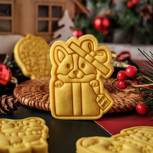 Christmas Corgi cookie in gift box shape with bow and With Love text on holiday background