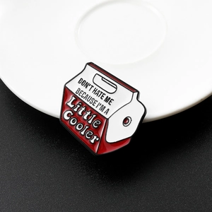 Macro view of vintage cooler enamel pin with Don't Hate Me Because I'm A Little Cooler slogan