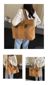 Detail view of brown canvas tote bag with adjustable straps and sturdy black buckles