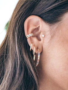 Macro view of model wearing S925 silver stud earrings and rainbow gemstone hoop earrings