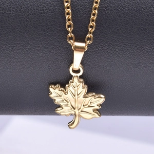 Detailed macro view of 18k gold plated maple leaf pendant on a stainless steel O-chain