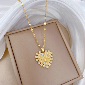 Detailed view of a gold heart pendant featuring a zircon frame and 3D honeybee relief