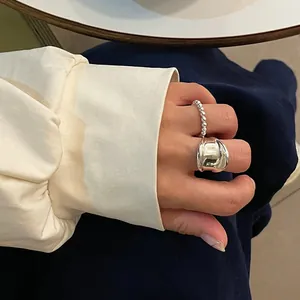Detailed view of a silver minimalist two-piece ring set with bead chain and wide band