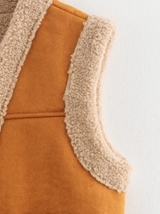 Close-up of brown suede vest with beige faux fur trim around collar and armholes