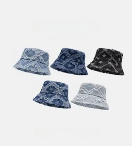 Detailed pile display of denim bucket hats with frayed star patterns in various blue tones