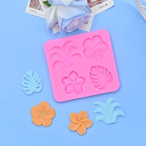 Pink silicone mold featuring tropical hibiscus and palm leaf shapes for fondant and clay