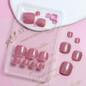 Close-up of pink glitter press-on toenails on a professional aesthetic background