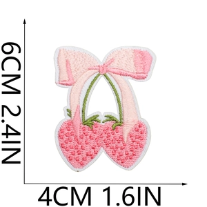 Close-up of pink strawberry bow embroidery patch showing dimensions 6x4cm and fine texture