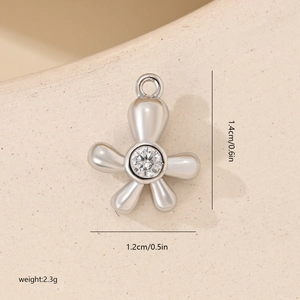 Detailed view of flower zircon pendant showing dimensions 1.4cm by 1.2cm and 2.3g weight