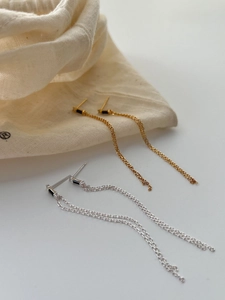 Detail of 925 sterling silver tassel earrings with black cubic zirconia in gold and silver