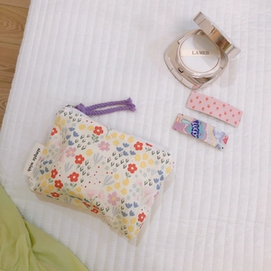 Floral cotton mini pouch with purple zipper for coins and cosmetics on white quilted mat