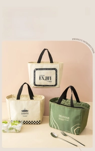 Detailed view of insulated lunch bags in cream and olive green with sturdy handles