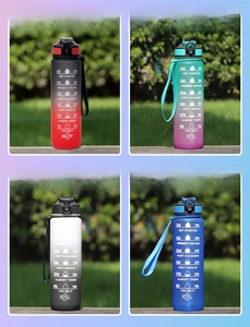 Detail view of 1L water bottles in four gradient colors with time marker on outdoor lawn