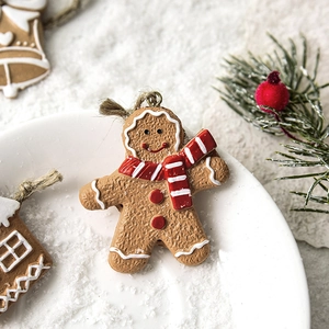 Resin gingerbread man Christmas ornament with striped scarf and rustic hanging twine