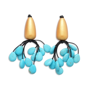 Vintage gold drop earrings with turquoise stone tassels and black cord on white background