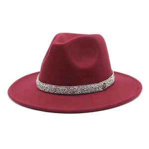 Detailed macro view of burgundy wool fedora hat featuring a sparkling rhinestone band and M charm