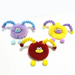 Cute plush monster keychains in purple, yellow, and red with decorative spiral horns
