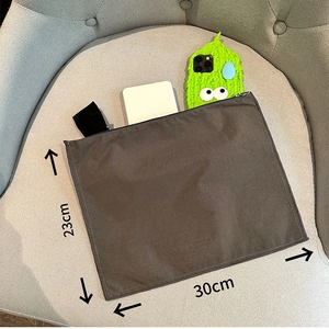 Dark gray nylon organizer bag with zipper and 30x23cm size dimensions on a chair