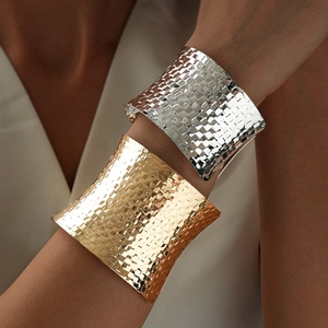 Wide woven geometric open bangle in polished gold and silver finish with hammer texture
