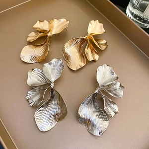 Vintage heavy metal petal stud earrings in gold and silver with elegant pleated texture