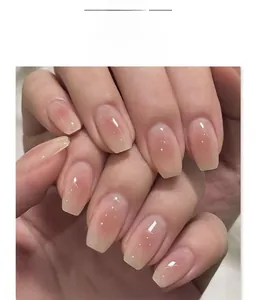 Macro shot of JP4100 almond press-on nails featuring pink blush gradient and silver glitter
