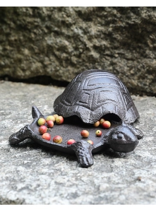 Detailed macro view of vintage cast iron turtle storage box shell texture and base